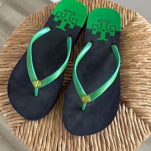 Tory Burch navy and green flip flops with logo.
